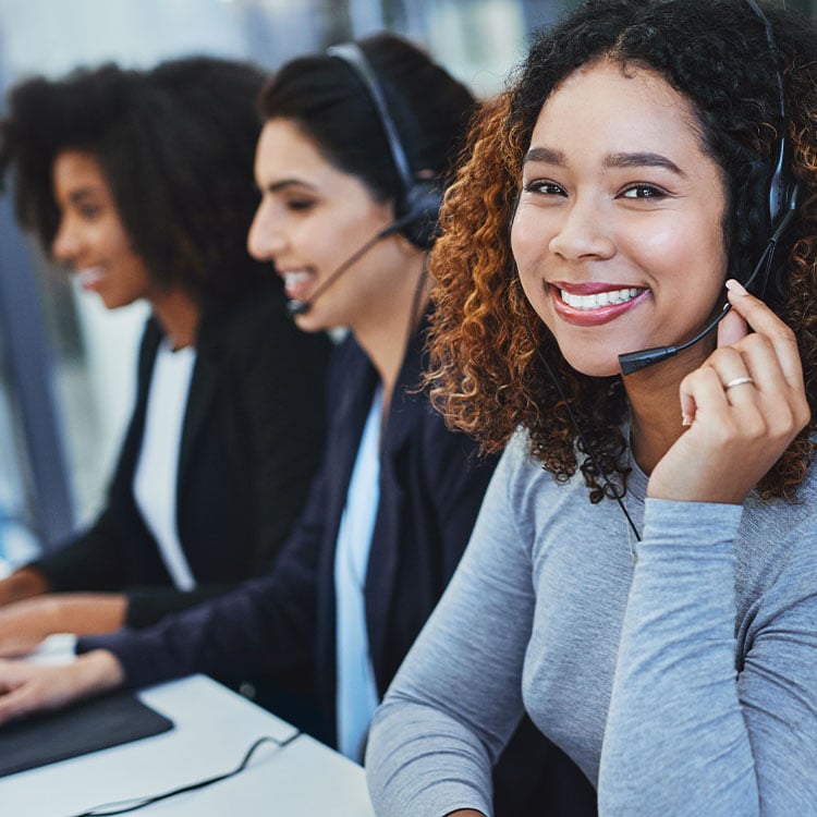 A row of customer support agents ready and waiting to help.