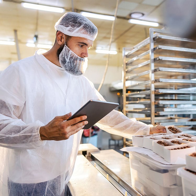 An employee inspecting produce.