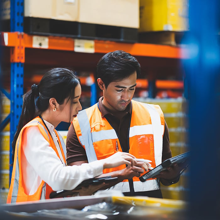 Warehouse employees having a look on an ipad.