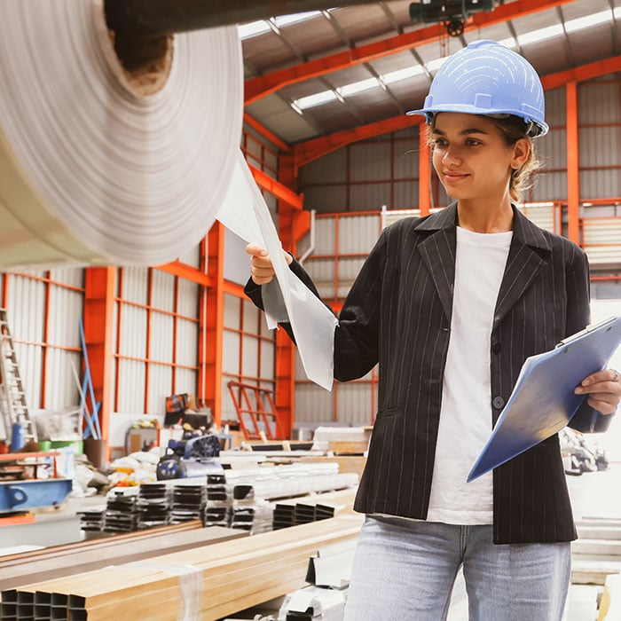 A female employee looking at material in a warehouse