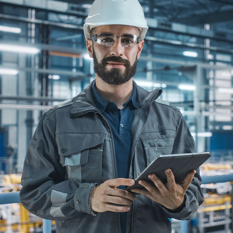 A worker using fully integrated ERP software seamlessly across his production