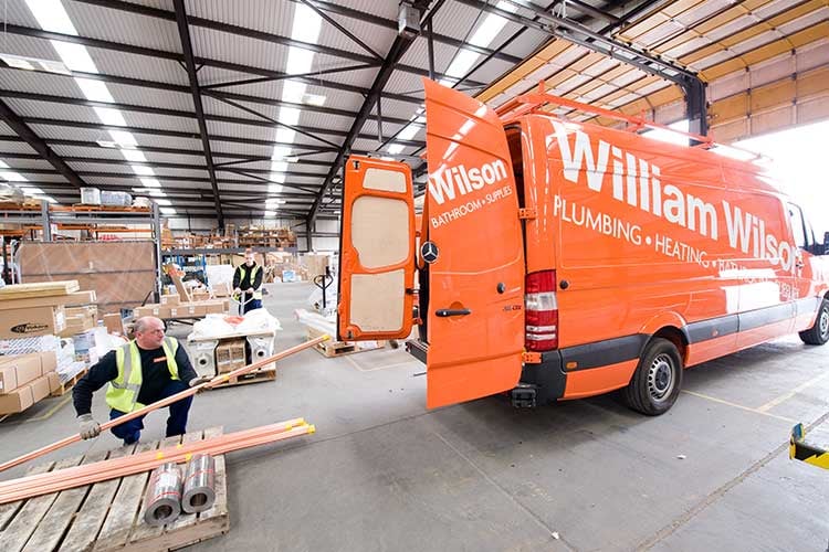 A William Wilson delivery van picking up supplies.